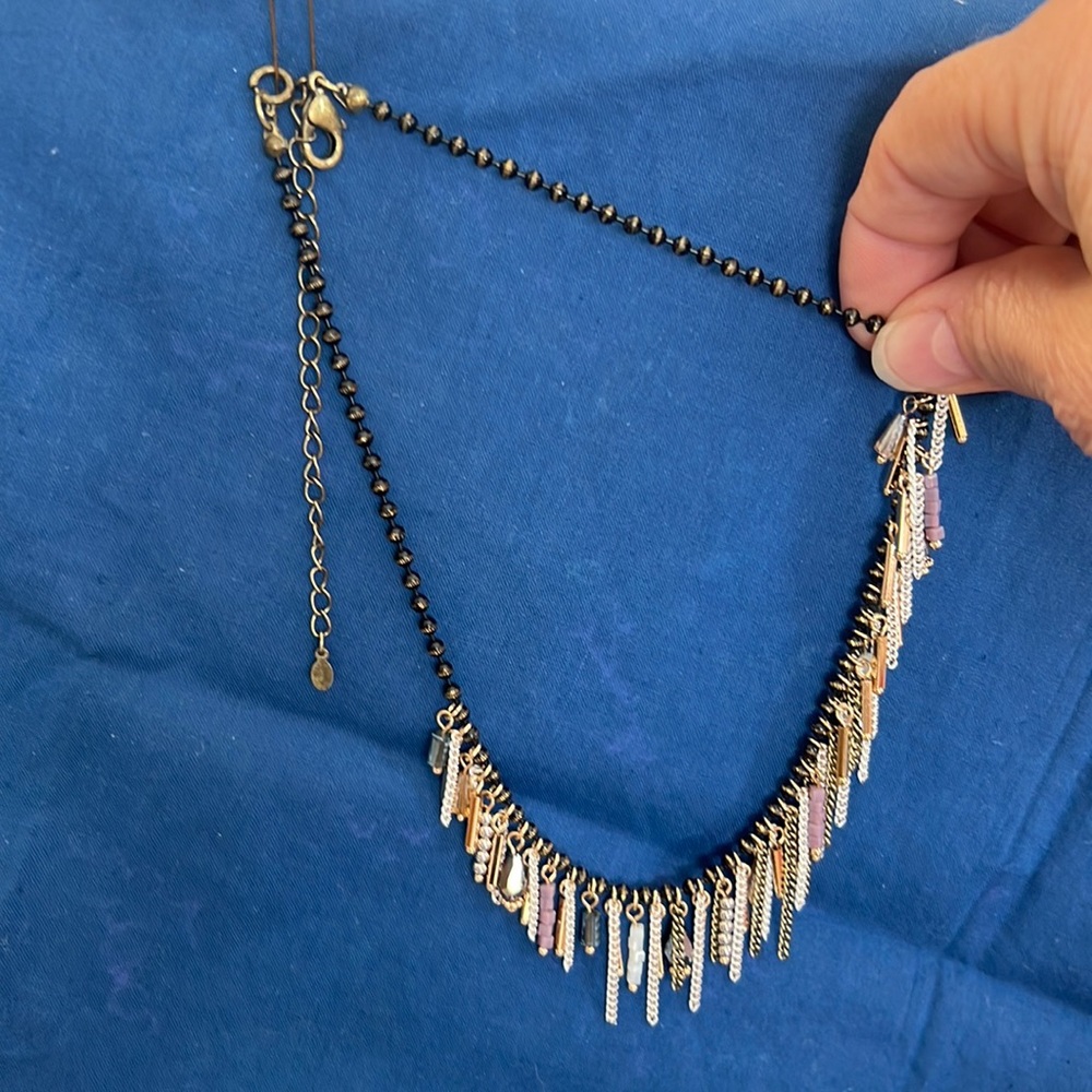 Premier Jewelry necklace with dark beads and gold, purple and white dangles.